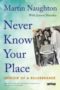 A book front cover with title 'Never Know Your Place' and subtitle 'Memoir of a Rulebreaker'. Author identified at top as 'Martin Naughton with Joanna Marsden'. Blue/green background with snapshot-style black and white 1970s photo of a smiling teenage Martin Naughton with brown hair in wheelchair with professional footballer Billy McNeill beside him and a curious crowd behind. O'Brien Press logo bottom right